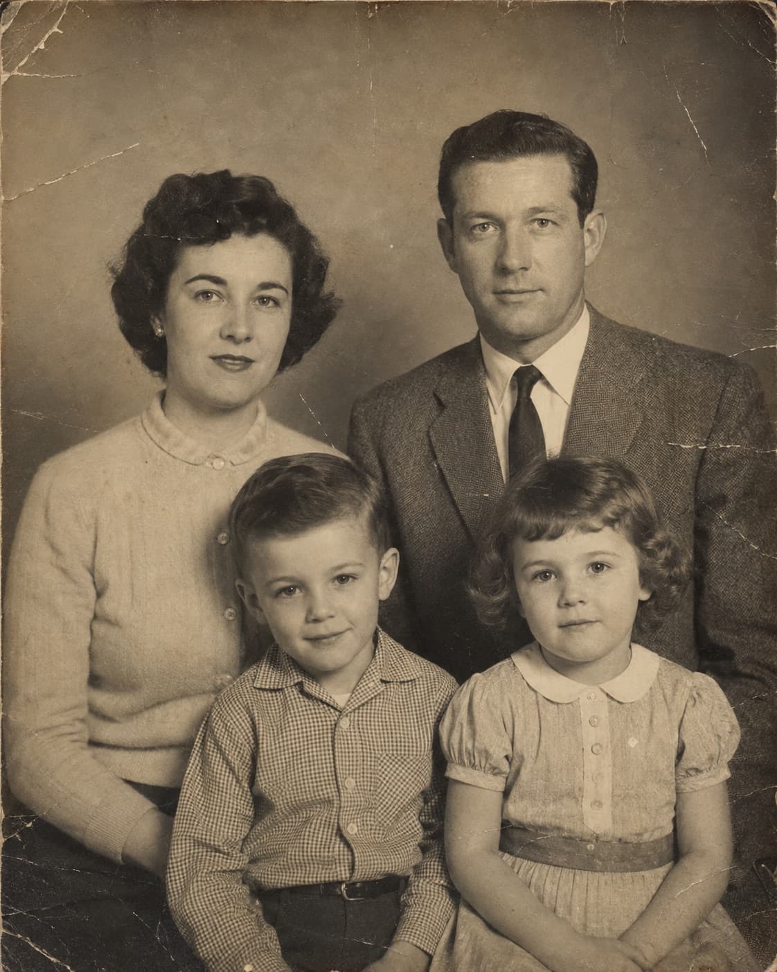 Faded and scratched 1950s family portrait
